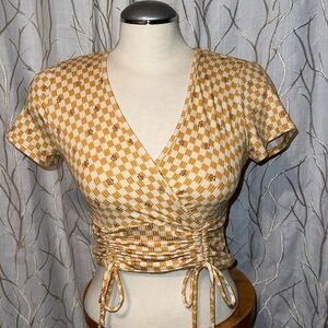 Yellow crop top. Flowers.